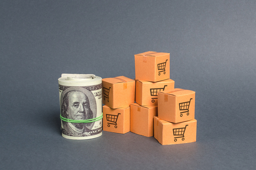 Roll bundle of dollars and cardboard boxes. International trade and trading balance. Global market and business, import and export of goods and services. Fees and trade wars. Economics and GDP.
