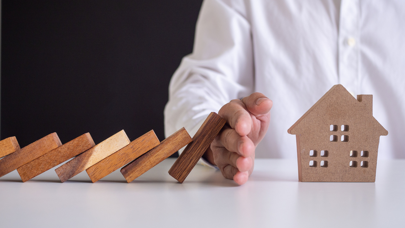 Insurance with Hands Protect a House